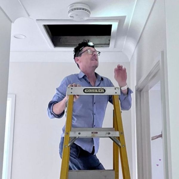 A Scorecard assessor inspecting a client’s insulation to advise on its adequacy.