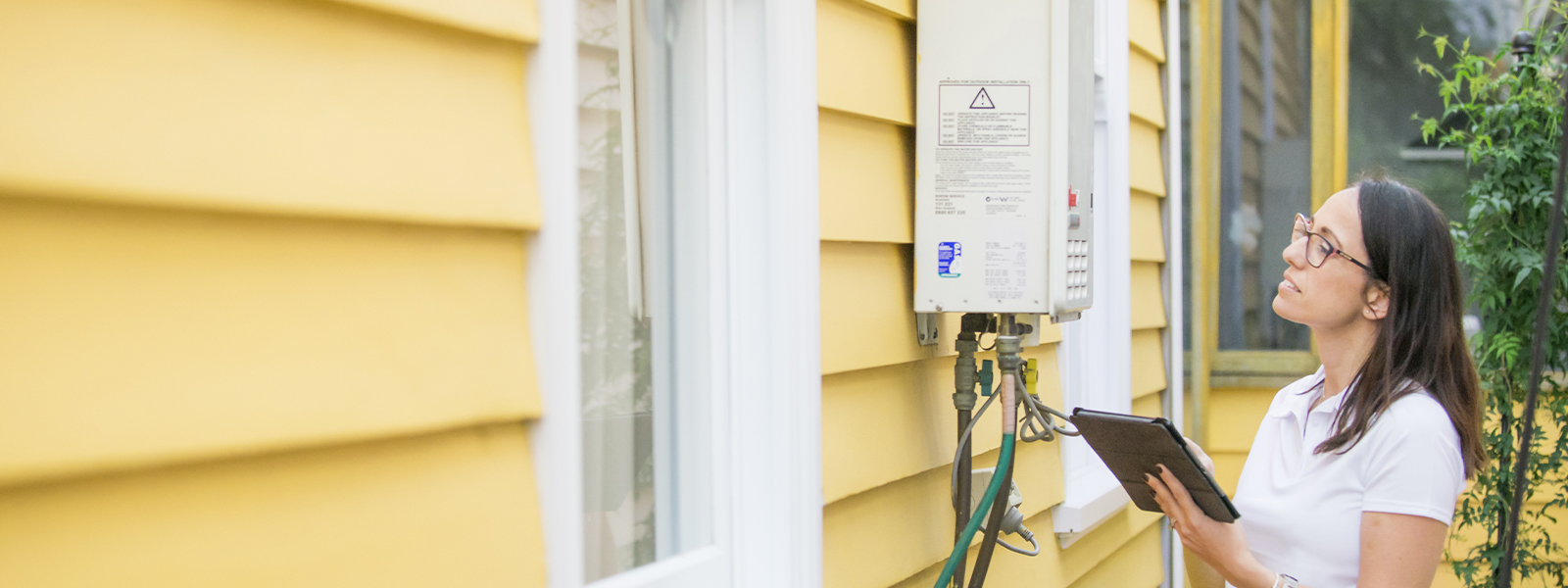 A Scorecard assessor enters hot water service data into a tablet device